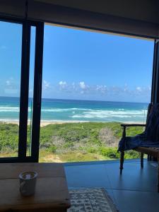 a view of the ocean from a room with a window at Marien Beach House in Glentana