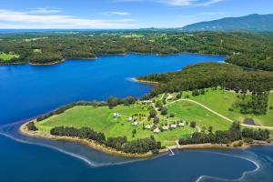 an aerial view of a large island in a lake at Black Bream Point Cabins in Narooma