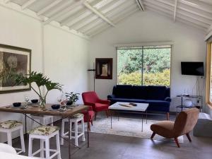 een woonkamer met een bank en een tafel en stoelen bij Casa de los Olivos! in Villa de Leyva