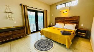 a bedroom with a bed and a large window at Estudio a 5 minutos de Sayulita -Parota 1 in San Ignacio +5 photos