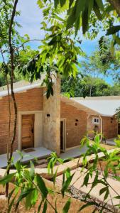 a brick building with a door in the middle at Vista Alegre Natural Resort - Bungalows in Independencia