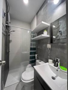 a bathroom with a toilet and a sink and a shower at La mejor Vista al Point de la Playa San Bartolo in San Bartolo