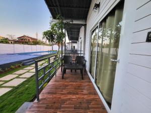 a porch with chairs on the side of a building at Rashiva Resort in Arambol