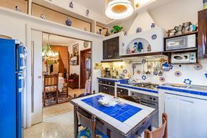 a kitchen with blue tiles on the counters at Villa Paola Private Pool Gym in Chianti - Happy Rentals in Montespertoli +40 photos