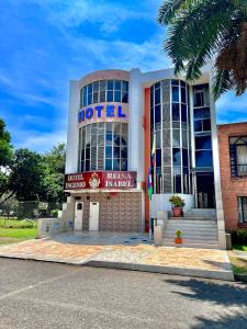 a hotel with a sign on the front of it at Hotel Ingenio Reina Isabel in Cali