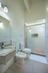 a bathroom with a toilet and a sink and a shower at Vista Alegre Natural Resort - Villas & Cabañas in Independencia