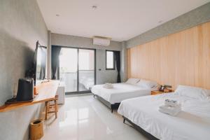 Rúm í herbergi á 宥心文旅You Sin B&B