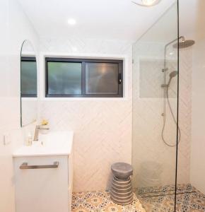 a bathroom with a sink and a shower at Island Hideaway + 1 min to Cylinder Beach + Sleeps 10 in Point Lookout