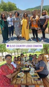 un grupo de personas de pie alrededor de una mesa en Olive Country Lodge - Eswatini, en Ngwempisi