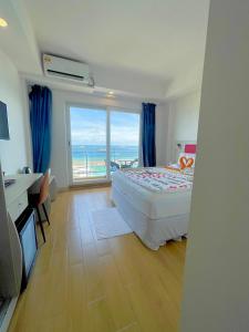 a bedroom with a bed and a view of the ocean at iCom Marina Sea View in Maafushi