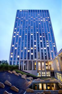 a tall building with a lot of windows in front of it at Shama Heda Serviced Apartment in Hangzhou