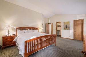 a bedroom with a large bed with a wooden frame at Boulder Brook on Fall River in Estes Park