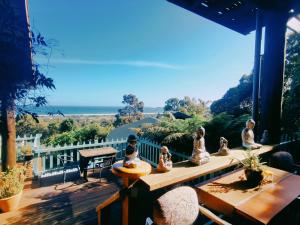 a balcony with figurines of people sitting on a table at The Goat and Goose Bed & Breakfast in Lakes Entrance