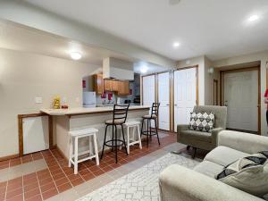 a kitchen and living room with a couch and a table at Chic 2br - 2 Min From Icubs in Des Moines