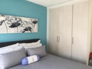 a bedroom with a bed and a painting on the wall at Karaboapartlodge in Jane Furse
