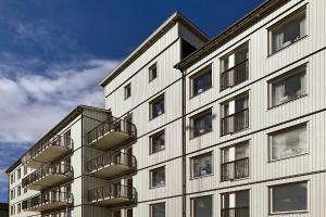 a building with balconies on the side of it at Guestly Homes - 1BR Corporate Comfort in Boden