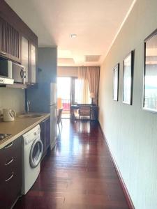 a kitchen with a washer and dryer in a room at Panoramic sea view, 1 bed flat in Ban Bang Bao