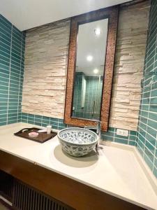a bathroom with a bowl sink and a mirror at Panoramic sea view, 1 bed flat in Ban Bang Bao
