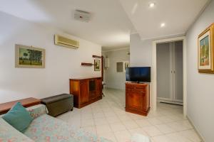 a living room with a couch and a flat screen tv at Eleonora House - Happy Rentals in Alassio
