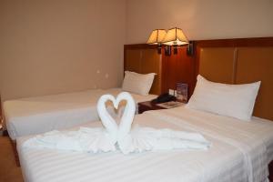 Postel nebo postele na pokoji v ubytování Dansavanh Vientiane Hotel