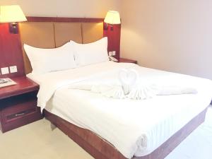 Postel nebo postele na pokoji v ubytování Dansavanh Vientiane Hotel