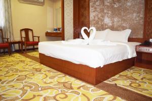 Postel nebo postele na pokoji v ubytování Dansavanh Vientiane Hotel