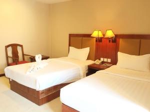 Postel nebo postele na pokoji v ubytování Dansavanh Vientiane Hotel + 22 fotografií