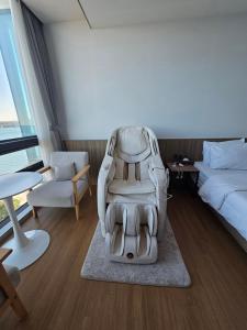 a hotel room with a car seat sitting on a rug at The Van Hotel in Ulsan