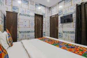 een slaapkamer met een bed en een tv aan de muur bij FabExpress Cash in Mohali