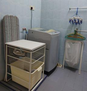 a bathroom with a washing machine and a sink at Cosy Home + Mini Golf in Kuantan in Kuantan