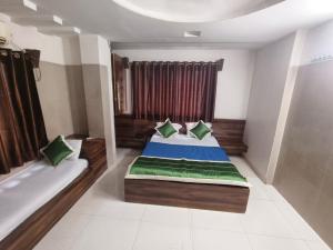 a bedroom with a bed and a window at HOTEL SAI PRABHU INN in Shirdi