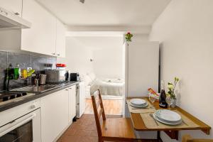 a kitchen with a table and a refrigerator at Apartment View And Pool - Happy Rentals in Agno