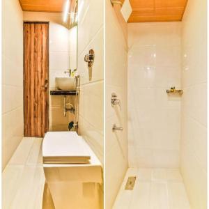 uma casa de banho com um chuveiro, um WC e um lavatório. em GATEWAY INN em Mumbai