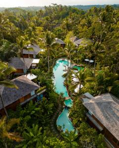 an aerial view of a resort with a pool and trees at Kappa Senses Ubud in Ubud
