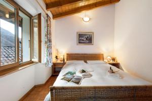 a bedroom with a bed with two books on it at Casa Lara - Happy Rentals in Lugano