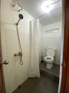 a bathroom with a shower and a toilet in it at ReVive by Snooze in Banyuwangi