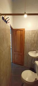 łazienka z toaletą i umywalką w obiekcie Casa de campo en Bellavista w mieście Puerto Ayora