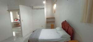 a bedroom with a bed in a white room at Casa de campo en Bellavista in Puerto Ayora +2 photos