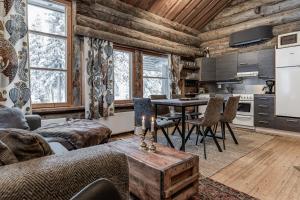 a kitchen and living room with a table and chairs at Ruka Villa Pipo slopes, skiing, lake in Ruka