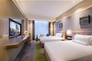 En eller flere senge i et værelse på Novotel Shanxi Yuncheng