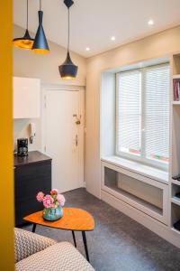 a living room with a table and a window at Appartement 11 place d'Alliance in Nancy