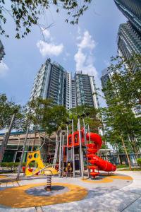 a playground in front of some tall buildings at Family Luxury Condo with Slides near Legoland, Medini Signature by KidsCastle in Nusajaya