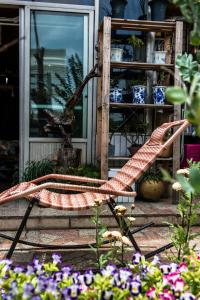 a bench in front of a house with flowers at Arthur's Roof-Top in Chengdu