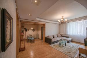 a living room with a couch and a table at Arthur's Roof-Top in Chengdu