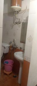 a bathroom with a sink and a toilet and a mirror at Hotel king palace in Chandīgarh