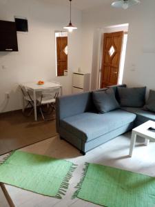 ein Wohnzimmer mit einem blauen Sofa und einem Tisch in der Unterkunft Historical Varkor Villa @ Koszeg Castle Wall 2 in Kőszeg