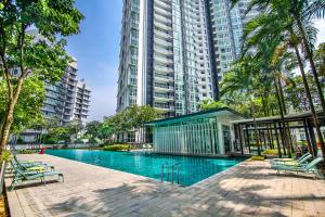 a swimming pool in a city with tall buildings at Family Luxury Condo with Slides near Legoland, Medini Signature by KidsCastle in Nusajaya