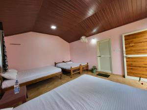 um quarto com duas camas e uma janela. em CoffeeINN Homestay - Private Cottages, Jeep Ride, Home Food em Sakleshpur