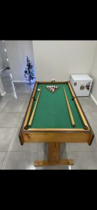 a pool table with cue sticks on top of it at Cosy Room with lock and work area in Truganina