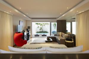 a living room with two beds and a couch at Double - Six, Luxury Hotel - Seminyak in Seminyak